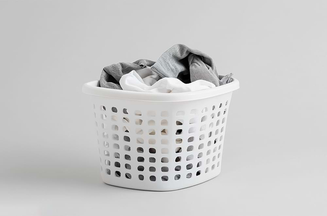 White plastic laundry basket with clothes