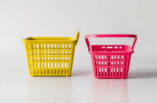 Colorful plastic shopping baskets yellow and pink