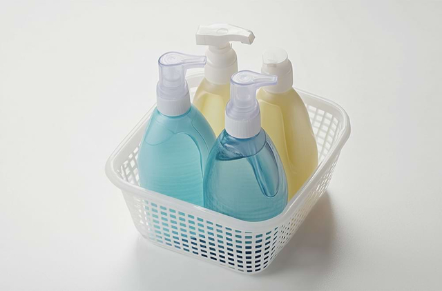 Cleaning supplies in storage basket with pump bottles